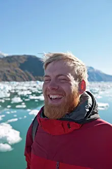 Adventure Prints: blonde man with beard laughing ot fjord in south Greenland