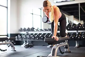 Biceps Prints: A blonde woman working out in a gym