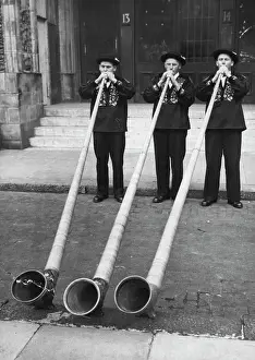 Arts Culture And Entertainment Prints: Blowing Their Own Trumpets! -- Swiss mountaineers demonstrating their skill on the 12 feet long wooden alp-horns