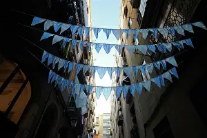 City Living Prints: Blue garlands spanned across a street