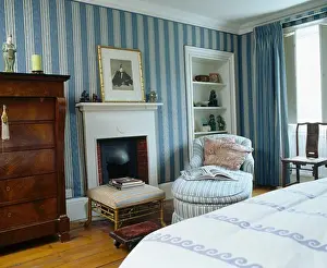 Bedrooms Prints: Blue striped wallpaper in townhouse bedroom with chaiselongue beside fireplace