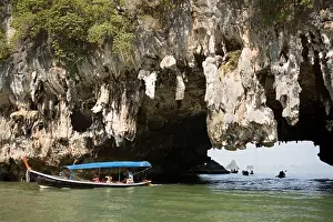 Paddle Prints: Boat passing a Karst formation