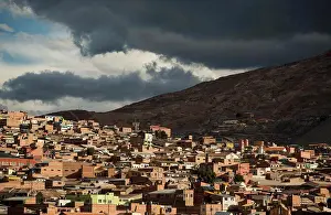 Weather Prints: Bolivia, Potosi, Aerial view of city buildings and hill under storm clouds