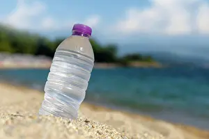 Beverage Prints: Bottle of fresh cold water on beach sand Bottle of cold fresh water on beach sand