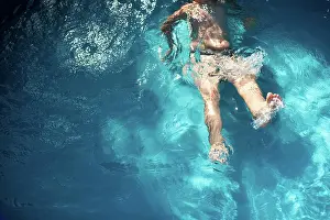 Gradeschooler Prints: Boy 7-8 years old kicks in pool water during summer time