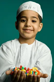Students Prints: Boy (8-9 years) holding colorful alphabets, smiling, portrait