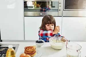 Culinary Prints: Boy, baking and mixing in home kitchen