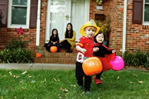 Bucket Prints: Boy dressed as fireman with trick or treat bucket