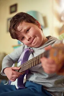 Electric Prints: Boy, electric guitar and portrait in home for music or performance