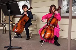 Columbus Prints: A boy holding cello looks on while his sister plays her instrument