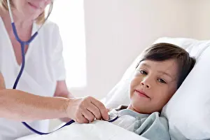 7 8 Years Prints: Boy in hospital bed, nurse using stethoscope