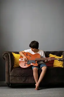 Positive Emotion Prints: Boy playing guitar in living room