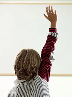 Instruction Prints: Boy raising hand in classroom