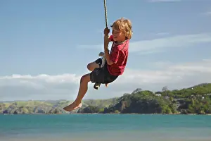 Model Release Prints: Boy on rope swing, Oakura Bay, Northland, North Island, New Zealand (MR)
