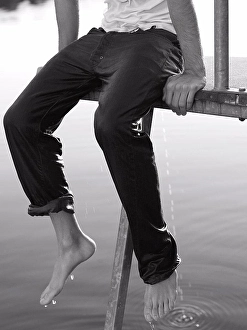 Boy Seated on Dock with Wet Clothes
