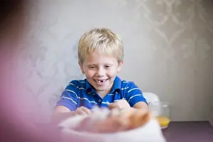 Provided Prints: Boy smiling at dinner table