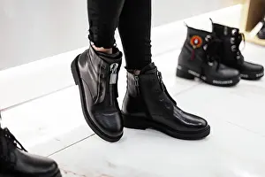 Lassig Prints: Boy Stylish Woman in black more fashionable jeans in fashionable leather boots is at the white at shop trendy