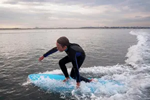 Child Hood Prints: A Boy Surfs At Nahant Beach In Nahant, Massachusetts