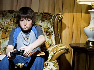 Model Release Prints: Boy with video game controller on sofa