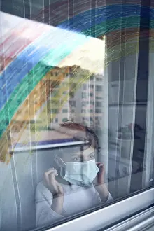 Thoughtful Prints: Boy behind window during quarantine