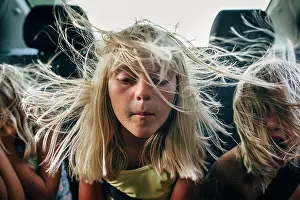 Gradeschooler Prints: boys and girls in backseat of car with hair blowing in wind