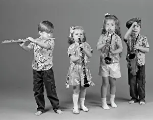 Instrument Prints: Two Boys And Two Girls Playing Flute Clarinet Trumpet And Saxophone Indoor