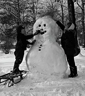 Snowman Prints: Two boys making snowman