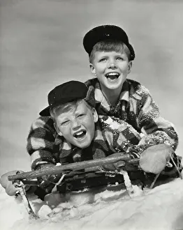 Baseball Cap Prints: Two boys sliding on a sled