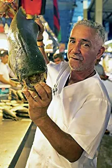 Tooth Prints: Brazilian man showing the large teeth of a black pacu or millstone tetra or tambaqui