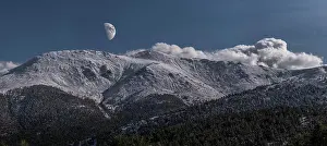 Wide Angle Prints: Breathtaking wide angle view of snowy mountain range against evening sky with white clouds and moon in nature