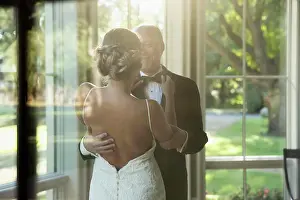 Bald Prints: Bride fixing her fathers bow tie, seen through window