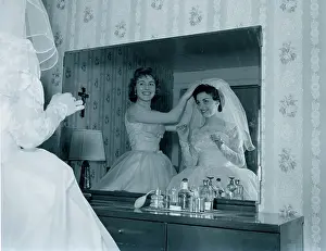 Life Events Prints: Bridesmaid attaching veil to bride's hair in front of mirror