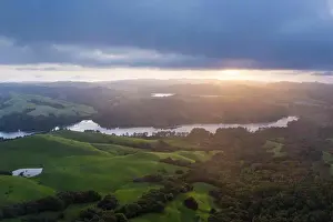 Hills Prints: A Brilliant Sunrise Spreads Ray across Green Mountain Valley and Lake