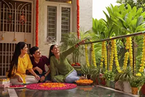 Occasion Prints: Brother and sister decorating the house together on the occasion of Diwali