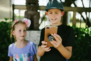 8 10 Years Old Prints: Brother and sister use smart phone together