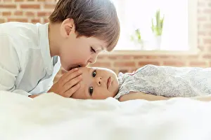 Tender Prints: Brother softly kissing his little sister on her forehead
