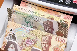 Financial Prints: Brunei dollar in the counting machine Brunei money - dollar in the counting machine Copyright: xZoonar