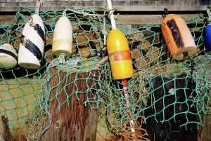 Buoy Prints: Buoys and a fishing net hanging to the edge of a dock at Menemsha Harbor