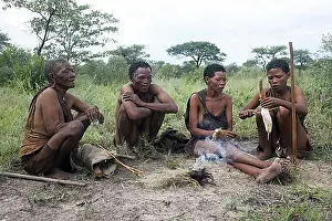 Lighted Prints: Bushmen cooking roots on handmade fire in the Kalahari desert near Ghanzi