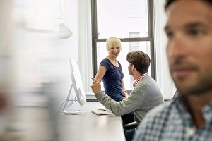 Business And Occupation Prints: Three business colleagues in an office, two talking and one standing by the door listening