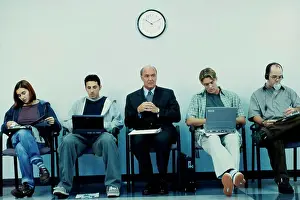 Businesswomen Prints: Business executives sitting in a row operating laptops