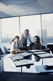 Businesswomen Prints: Three business executives working in an office