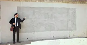 Professionalism Prints: Business, man and pointing to brick wall in city of advertising