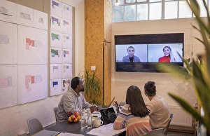 Multiracial Group Prints: Business people video conferencing with colleagues in meeting