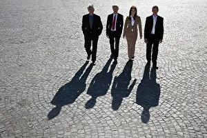 Networks Prints: Business people walking on cobbled road