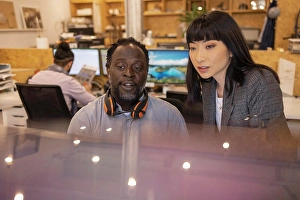 Multiracial Group Prints: Business people working together in office