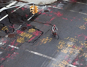 File Prints: Businessman cycling along city road, high angle view