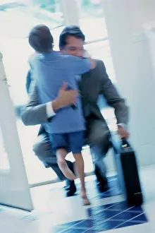 Blurred Motion Prints: Businessman hugging his son at the door