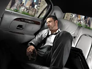 Trips Prints: Businessman sleeping in the back seat of a limousine