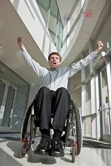 Handicapped Prints: Businessman with spinal cord injury in a wheelchair with his arms raised